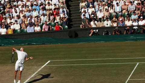 Germany's Alexander Zverev serves to Italy's Jannik Sinner during their men's singles final tennis match on the fourteenth day of the 2026 Wimbledon Championships at The All England Lawn Tennis and Croquet Club in Wimbledon, southwest London, on July 12, 2026. (Photo by Adrian Dennis/AFP)/RESTRICTED TO EDITORIAL USE