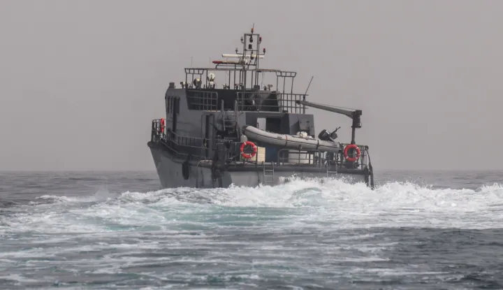 A vessel of the navy of Yemen's Aden-based internationally recognised government patrols a shipping lane off Hanish Island in the Red Sea on July 27, 2026. A Houthi spokesman said on July 24 that the rebels were not blocking traffic through the strategic Bab al-Mandeb Strait, after they declared a maritime embargo this week on their foe Saudi Arabia. The Iran-backed group attacked a Saudi ship in the nearby Red Sea after announcing the blockade, which threatens the top oil exporter's ability to get its supplies to the world following Iran's parallel blockade of the Strait of Hormuz, the kingdom's only other maritime route. (Photo by Khaled ZIAD/AFP)/