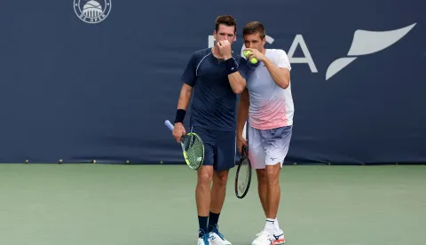 WASHINGTON, DC - AUGUST 02: Austin Krajicek of the United States and Nikola Mektic of Croatia talk during a men's doubles championship match against Julian Cash and Lloyd Glasspool of Great Britain on the final day of the Mubadala DC Open 2026 at William H.G. FitzGerald Tennis Center on August 02, 2026 in Washington, DC. Emilee Chinn/Getty Images/AFP (Photo by Emilee Chinn/GETTY IMAGES NORTH AMERICA/Getty Images via AFP)