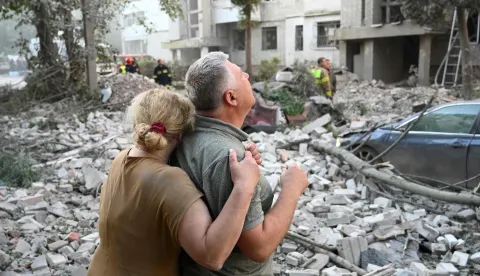 TOPSHOT - Local residents react outside a residential building partially destroyed as a result of Russian missile strikes in the western Ukrainian city of Lviv on July 30, 2026, amid the Russian invasion in Ukraine. Officials in Ukraine's eastern Poltava region, meanwhile, said one person was killed in a drone strike on a warehouse, while at least 15 people were wounded in attacks on the western city of Lviv. Russia launched 74 missiles and 284 drones at Ukraine last night, according to Kyiv on July 30, 2026. (Photo by YURIY DYACHYSHYN/AFP)