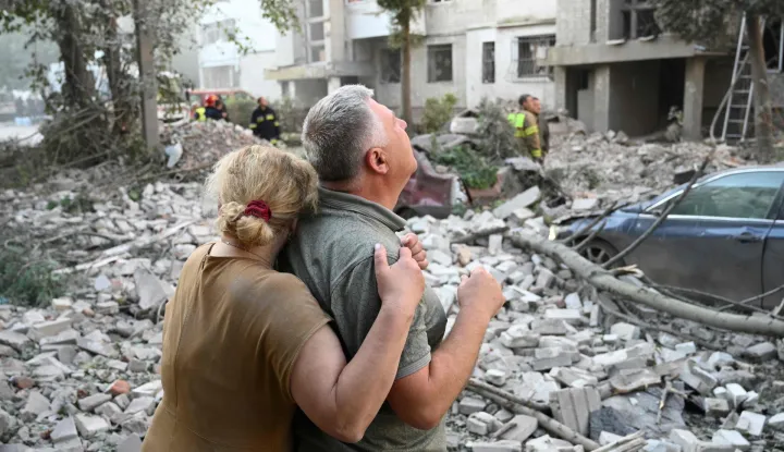 TOPSHOT - Local residents react outside a residential building partially destroyed as a result of Russian missile strikes in the western Ukrainian city of Lviv on July 30, 2026, amid the Russian invasion in Ukraine. Officials in Ukraine's eastern Poltava region, meanwhile, said one person was killed in a drone strike on a warehouse, while at least 15 people were wounded in attacks on the western city of Lviv. Russia launched 74 missiles and 284 drones at Ukraine last night, according to Kyiv on July 30, 2026. (Photo by YURIY DYACHYSHYN/AFP)
