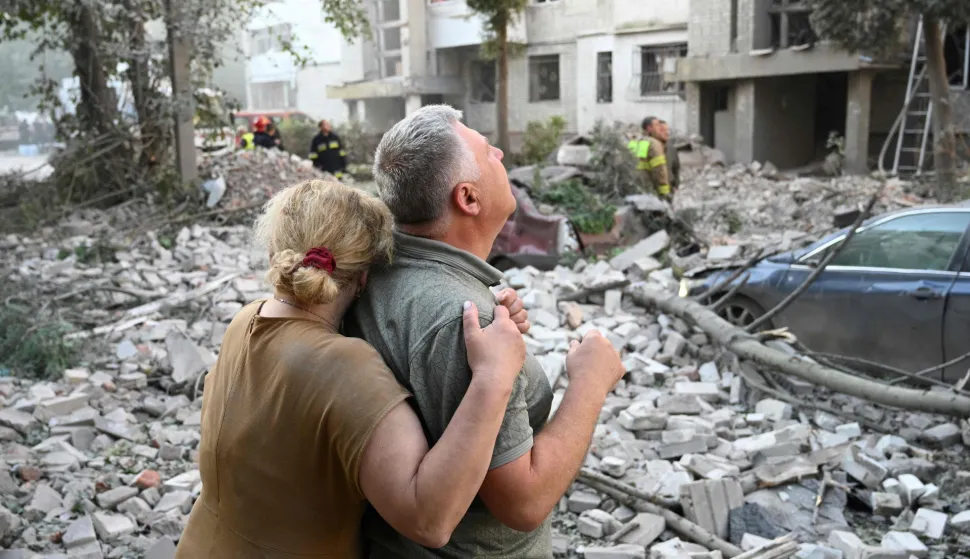 TOPSHOT - Local residents react outside a residential building partially destroyed as a result of Russian missile strikes in the western Ukrainian city of Lviv on July 30, 2026, amid the Russian invasion in Ukraine. Officials in Ukraine's eastern Poltava region, meanwhile, said one person was killed in a drone strike on a warehouse, while at least 15 people were wounded in attacks on the western city of Lviv. Russia launched 74 missiles and 284 drones at Ukraine last night, according to Kyiv on July 30, 2026. (Photo by YURIY DYACHYSHYN/AFP)