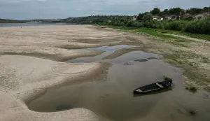 An aerial view shows a dried-out river bed of Danube in Rasova village August 3, 2026. Romanian army forces detonated an explosive load into the rock bed of Danube in Izvoarele village, kilometers away from Rasova, to help diverting a higher volume of water toward the cooling systems of the Cernavoda Nuclear Power Plant. Local authorities and plant engineers authorized the blasting operations to counteract critically low water levels caused by a prolonged summer heatwave, ensuring the continuous and safe operation of the facility's reactors. (Photo by Daniel MIHAILESCU/AFP)