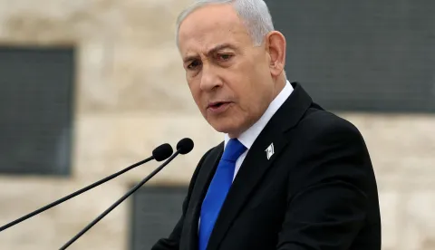 (FILES) Israel?s Prime Minister Benjamin Netanyahu speaks during a ceremony commemorating Israel?s Remembrance Day for fallen soldiers, or Yom HaZikaron, at the Military Cemetery on Mount Herzl in Jerusalem on April 21, 2026. Israeli Prime Minister Benjamin Netanyahu said on June 21, 2026, that Israeli forces would remain in southern Lebanon "as long as necessary", while also vowing to prevent Iran from acquiring nuclear weapons. (Photo by Ilia YEFIMOVICH/POOL/AFP)