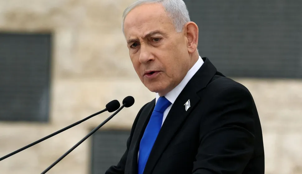 (FILES) Israel?s Prime Minister Benjamin Netanyahu speaks during a ceremony commemorating Israel?s Remembrance Day for fallen soldiers, or Yom HaZikaron, at the Military Cemetery on Mount Herzl in Jerusalem on April 21, 2026. Israeli Prime Minister Benjamin Netanyahu said on June 21, 2026, that Israeli forces would remain in southern Lebanon "as long as necessary", while also vowing to prevent Iran from acquiring nuclear weapons. (Photo by Ilia YEFIMOVICH/POOL/AFP)