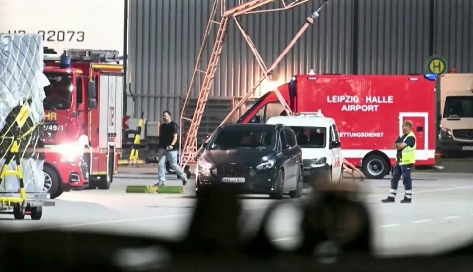 A video grab taken from a video footage by News5 from August 5, 2026 shows emergency services, police and firefighers deployed at German airport Leipzig-Halle in Schkeuditz, eastern Germany, after a drone was spotted nearby. German police deployed a bomb disposal robot at the airport after a drone was found near a Ukrainian-flagged cargo plane overnight, also forcing the diversion of numerous flights. Another aircraft, which had to abort its scheduled landing at Leipzig-Halle airport, then collided mid-air with an unknown object several kilometres away but later landed safely, the government said. The airport in eastern Germany plays a key role in the transport of military goods, including by the German military and NATO allies, and also serves as a base for Ukraine's Antonov Airlines. (Photo by NEWS5/AFP)