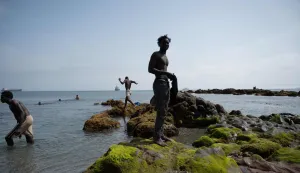 Migrants cool off in the sea at Trampolin beach, as they await entry to the CETI short-stay migrant center in the Spanish North African enclave of Ceuta, on August 1, 2026. At least 67 people have died in a recent surge of migrant crossings from Morocco to Spain's North African enclave of Ceuta, Spain's Interior Minister said today. Most of the 60,000 migrants who entered Ceuta over the space of a few days from neighbouring Morocco have already returned to Morocco. (Photo by JORGE GUERRERO/AFP)