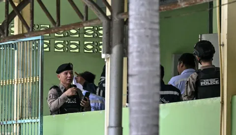 Police and emergency responders are pictured on the school premises following a shooting in Bang Kruai district, Nonthaburi province, north of Thailand's capital Bangkok, on August 7, 2026. At least four people were killed and 15 students injured during a school shooting just north of the Thai capital Bangkok on August 7, the deputy interior minister said. (Photo by Lillian SUWANRUMPHA/AFP)