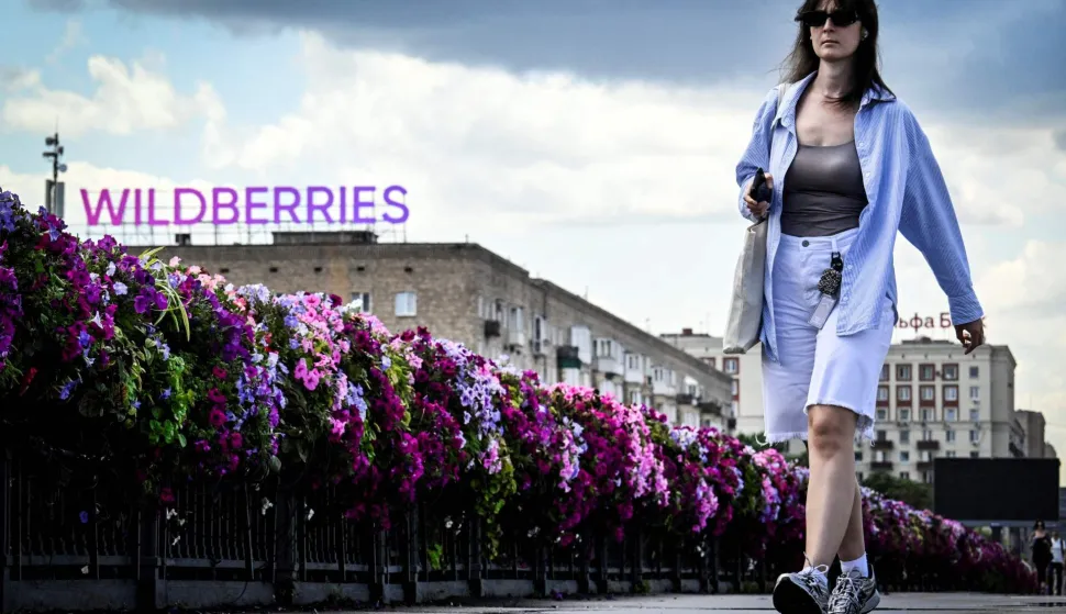 A woman walks past Russian e-commerce giant Wildberries' logo in downtown Moscow on July 27, 2026. Wildberries -- Russia's version of Amazon -- has been targeted by Kyiv's drones for a week, which have caused fires and business losses. Kyiv has in recent months intensified its strikes on Russian territory, disrupting the lives of ordinary Russians -- strikes it calls retribution for more than four years of bombardments against its territory. (Photo by Alexander NEMENOV/AFP)