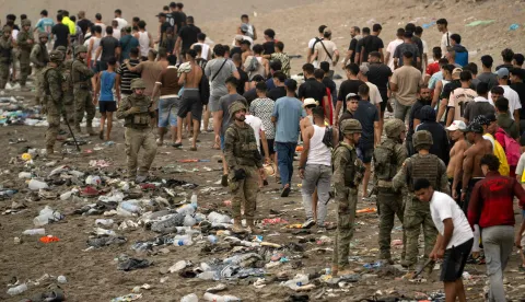 Spanish soldiers control as migrants cross back to Morocco after they crossed the border to enter Spain's north Africa's Ceuta enclave on July 31, 2026. Thousands of migrants crossed overnight from Morocco into Ceuta enclave, a police source said, as Spanish Prime Minister was set to arrive to manage the latest migrant crisis on the border. In recent days, a total of around 40,000 migrants have crossed into the territory, population 80,000, the source added. (Photo by JORGE GUERRERO/AFP)
