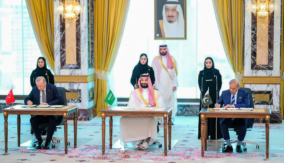 This handout photograph taken and released by Pakistan's Prime Minister's Office on August 7, 2026 shows Saudi Crown Prince Mohammed bin Salman (C), Turkish President Recep Tayyip Erdogan (L) and Pakistani Prime Minister Shehbaz Sharif signing the Mecca Joint Defence Agreement in Mecca, Saudi Arabia. Saudi Arabia, Turkey and Pakistan signed a joint defence agreement on August 7 amid violence in the region from Houthi attacks and the US-Iran war. (Photo by Handout/Pakistan Prime Minister's Office/AFP)/RESTRICTED TO EDITORIAL USE - MANDATORY CREDIT "AFP PHOTO /Pakistan Prime Minister's Office/ HANDOUT/" - NO MARKETING NO ADVERTISING CAMPAIGNS - DISTRIBUTED AS A SERVICE TO CLIENTS