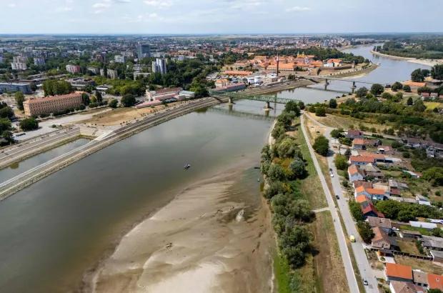 An aerial view shows a panorama of the city and an old ship (down, centre) exposed by receding water due to low water levels on the Drava River, in Osijek, Croatia, on August 8, 2026. (Photo by MARKO PERKOV/AFP)