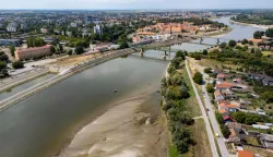 An aerial view shows a panorama of the city and an old ship (down, centre) exposed by receding water due to low water levels on the Drava River, in Osijek, Croatia, on August 8, 2026. (Photo by MARKO PERKOV/AFP)