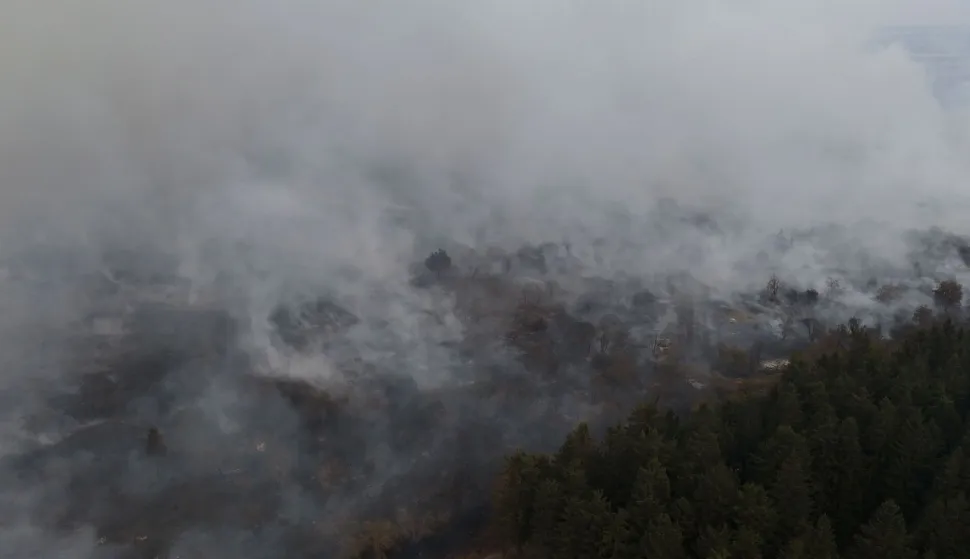 This aerial photograph shows a wildfire burning in the Hautes Fagnes (High Fens) nature reserve in Waimes on August 15, 2026. Residents began evacuating from two villages in eastern Belgium on August 15, 2026 as firefighters, backed by water bombers and helicopters from across Europe, battled one of the biggest wildfires in the country's history. Reinforcements from across the country were fighting the blaze which broke out on August 14, 2026 in the High Fens (Hautes Fagnes) natural park and quickly expanded burning an estimated 1600 hectares of the 4500 hectare reserve. (Photo by Dimitri KORCZAK/AFP)