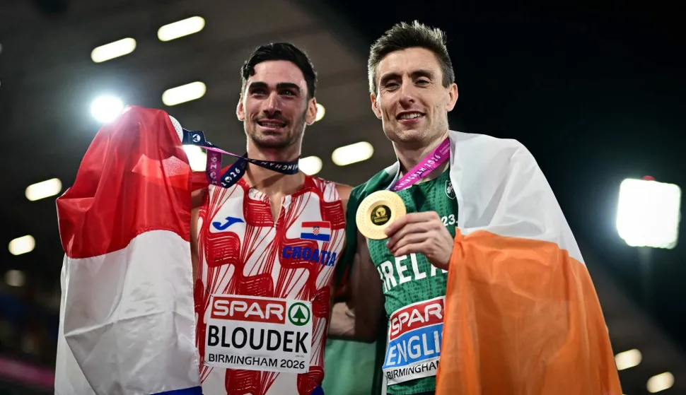 Silver medallist Croatia's Marino Bloudek (L) and gold medallist Ireland's Mark English celebrate after competing in the men's 800m final during the European Athletics Championships at Alexander Stadium in Birmingham on August 13, 2026. (Photo by Ben STANSALL/AFP)