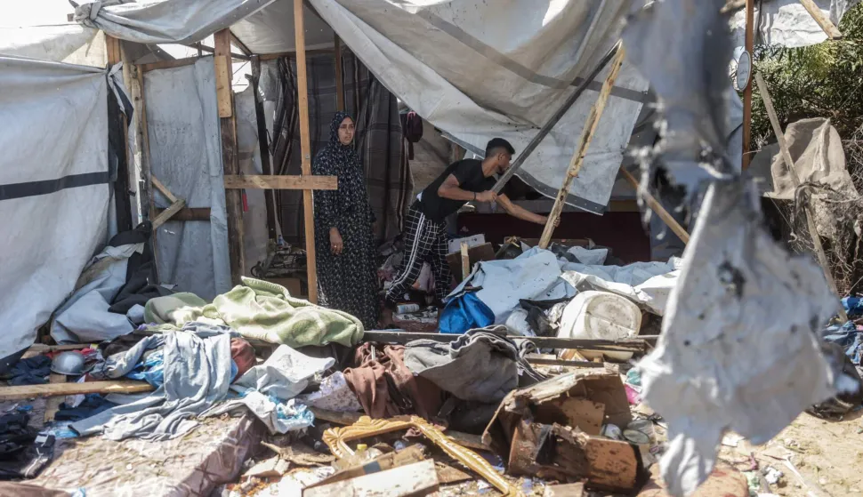 Displaced Palestinians inspect the damage at the site of an alleged Israeli strike on a tent in Khan Yunis, in the southern Gaza Strip, on August 16, 2026. US President Donald Trump's envoy and son-in-law Jared Kushner discussed Trump's Gaza plan with Egyptian President Abdel Fattah al-Sisi on August 16, hours after Hamas chief Khalil El-Hayya met with Egypt's spy chief. Kushner is set to travel next to Israel, which has publicly rejected a 15-point plan in which Hamas agreed to hand over its weapons to a new Palestinian governing committee in Gaza. (Photo by Bashar Taleb/AFP)