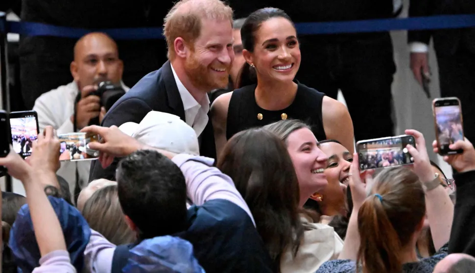 (FILES) Britain's Prince Harry, Duke of Sussex, and his wife Meghan, Duchess of Sussex, meet people at the Royal Children's Hospital in Melbourne, Australia, on April 14, 2026. Prince Harry and his wife Meghan, who cut ties with the British royal family in 2020, are moving back to the United Kingdom, British press reported on August 19, 2026. In a surprise move, the youngest son of King Charles III and Meghan, "plan to leave the United States by the end of the month to settle in a private, non-royal residence, which is said to be located outside London," The Telegraph said. (Photo by William WEST/AFP)