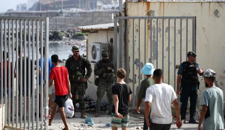 Migrants cross the Ceuta-Morocco border gate in the Spanish North African enclave of Ceuta on August 1, 2026. At least 67 people have died in a recent surge of migrant crossings from Morocco to Spain's North African enclave of Ceuta, Spain's Interior Minister said today. Most of the 60,000 migrants who entered Ceuta over the space of a few days from neighbouring Morocco have already returned to Morocco. (Photo by Henry NICHOLLS/AFP)