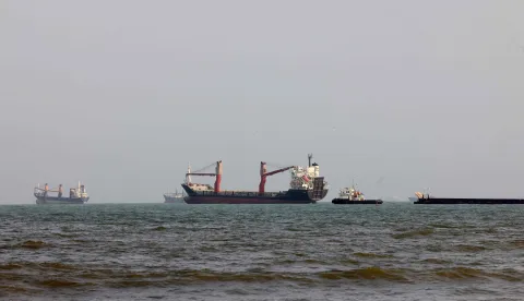 Vessels are seen in the Strait of Hormuz, off the port city of Bandar Abbas in southern Iran on August 10, 2026. The US President signalled on August 9 that he was prepared to let economic pressure mount against Iran, apparently backing away from more military strikes after Tehran issued a list of demands for opening the Strait of Hormuz. His remarks came after Iran issued over the weekend a list of conditions to reopen the Strait of Hormuz, which has remained largely closed since the start of the Middle East war in late February. (Photo by Atta KENARE/AFP)/