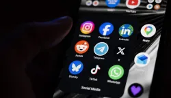 (FILES) This photograph shows a set up smart-phone screen displaying the logo of main social media platforms including Instagram, Facebook, LinkedIn, Reddit, Telegram, X, Bluesky, Tiktok and Whatsapp in Saint-Mande, east of Paris, on April 29, 2026. On August 14, 2026, the French Constitutional Council struck down the ban on social media for under-15s, ruling that this measure constitutes "a disproportionate infringement" of their freedom of expression. (Photo by Martin LELIEVRE/AFP)