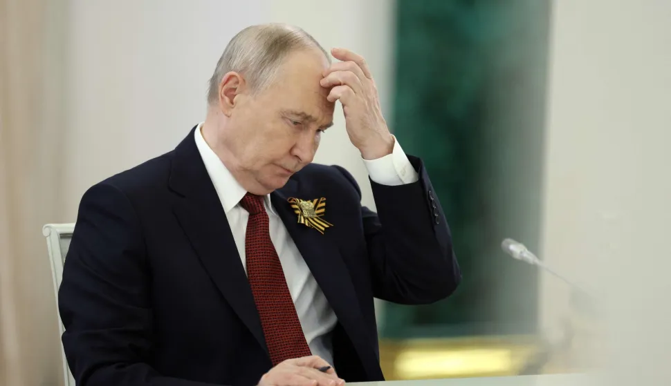 TOPSHOT - Russian President Vladimir Putin attends a meeting with Laotian President at the Kremlin in Moscow on May 9, 2026. (Photo by Ramil Sitdikov/POOL/AFP)
