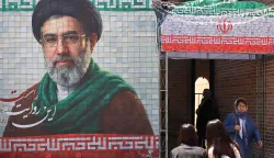 A commuter walks past a large tiled image of Iran's current leader Ayatollah Mojtaba Khamenei, at the entrance to the metro in Tehran on May 9, 2026. (Photo by ATTA KENARE/AFP)/
