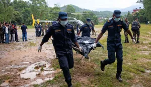 Nepali Army personnel carry bodies of deceased victims during rescue operations after flash floods, at Trishuli camp in Nepal's Nuwakot district on August 28, 2026. More than 1,400 people are missing and at least 552 have been killed after a devastating, tsunami-like wall of water gouged a path through the border region between Nepal and Tibet, sweeping away entire villages. (Photo by PRABIN RANABHAT/AFP)