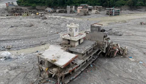 An aerial view shows damaged building in the aftermath of flash floods, near Trishuli river at Betrawati in Nepal's Nuwakot district on August 29, 2026. More than 3,000 people were listed as missing on August 30, with another 768 confirmed dead, after the flash floods and landslides that hit the Nepal-Tibet border. (Photo by Prabin RANABHAT/AFP)