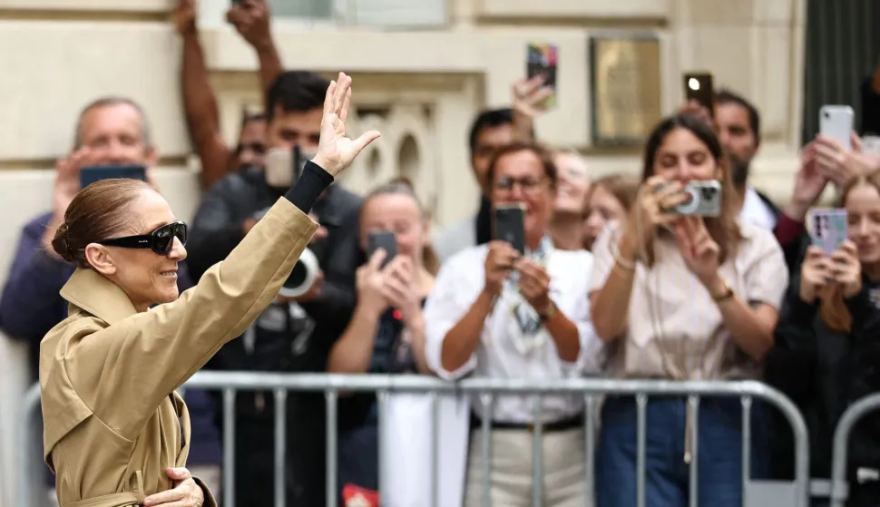 Canadian singer Celine Dion acknowledges fans as she arrives at Hotel Le Royal Monceau in Paris on August 28, 2026, ahead of he series of concerts in the French capital. Celine Dion, 58, announced in late March, in a video and a message projected onto the Eiffel Tower, her return to the stage, in Paris, after six years away from the public, between the pandemic and persistent health problems. She has suffered since 2022 from stiff person syndrome, a rare and incurable neurological condition. (Photo by SIMON WOHLFAHRT/AFP)
