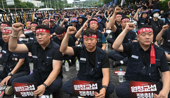Members of the Korean Metal Workers' Union shouts slogans during a joint strike rally in front of the Hyundai Motor headquarters in Seoul on August 21, 2026. The union representing workers at South Korean automaker Hyundai Motor staged its first full-day strike in 10 years on August 21, after long-running wage and retirement age talks with management broke down. (Photo by Jung Yeon-je/AFP)
