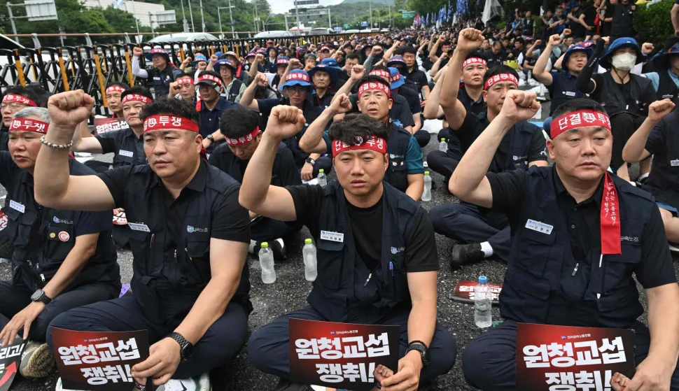 Members of the Korean Metal Workers' Union shouts slogans during a joint strike rally in front of the Hyundai Motor headquarters in Seoul on August 21, 2026. The union representing workers at South Korean automaker Hyundai Motor staged its first full-day strike in 10 years on August 21, after long-running wage and retirement age talks with management broke down. (Photo by Jung Yeon-je/AFP)