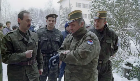 (FILES) Bosnian Serb General Ratko Mladic (2R) checks his watch at the Lukavica barracks in the surburbs of Sarajevo on February 15, 1994. Former Bosnian military Serb leader and war criminal Ratko Mladic has died in a prison hopsital in the Hague, according to Serbian state broadcaster RTS on August 27, 2026, after suffering several strokes. Mladic, 84, was dubbed the "Butcher of Bosnia" for his role in the 1995 Srebrenica massacre during the Bosnian war. (Photo by Pascal GUYOT/AFP)