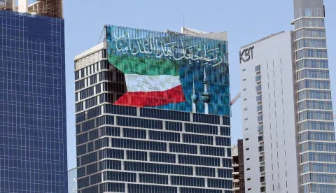 A large screen displays a verse from the Koran reading "My Lord, make this city secure," alongside the Kuwaiti flag and the landmark Kuwait Towers, on a skyscraper in Kuwait City on September 2, 2026. Iran launched a wave of attacks on US sites across the Middle East on September 2, as violence surged after an extensive American bombardment and the deaths of four people at an Iranian wedding party. Iran's Revolutionary Guards announced attacks on US bases in Jordan, the UAE, Kuwait, Bahrain and Iraq's autonomous Kurdistan region, in the six-month conflict's heaviest exchange in weeks. (Photo by AFP)/