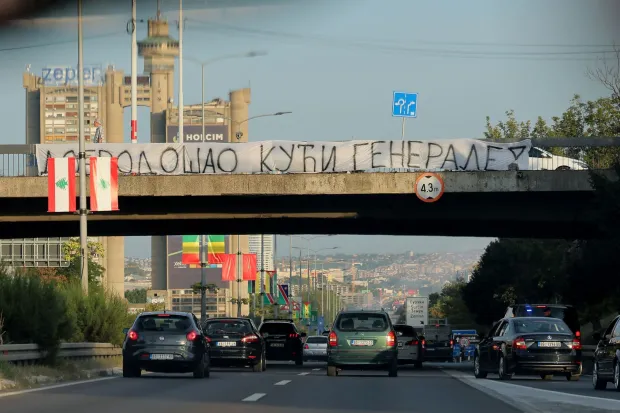 A banner reading "Welcome Home, General" is displayed on a footbridge over a motorway as a convoy carrying the body of Bosnian Serb war criminal Ratko Mladic passes through Belgrade, Serbia, on September 3, 2026. Mladic's body arrived in Serbia earlier in the day and was driven from the airport under police escort after being received with military honours. Mladic died the previous week while serving a life sentence for genocide, war crimes and crimes against humanity committed during the 1992-1995 Bosnian war. (Photo by Pedja MILOSAVLJEVIC/AFP)