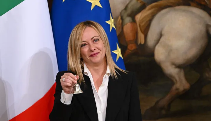 (FILES) Italy's new Prime Minister, Giorgia Meloni holds the cabinet minister bell handed to her by Italy's outgoing prime minister during a handover ceremony at Palazzo Chigi in Rome on October 23, 2022. Giorgia Meloni's hard-right government on September 2, 2026 becomes the longest-lasting in Italy's postwar history -- a notable record that belies considerable challenges ahead of elections next year. In a country once a byword for political instability, Italy's first woman leader will have been in charge of the same administration for 1,413 days, one more than the late Silvio Berlusconi managed during one of his four stints in office. (Photo by Andreas SOLARO/AFP)