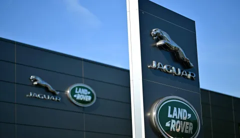 (FILES) Jaguar Land Rover signage is seen on a dealership in Tonbridge, south-east of London on September 29, 2025. British luxury carmaker Jaguar Land Rover announced on September 7, 2026 a voluntary redundancy scheme following months of turmoil caused by a cyberattack and US President Donald Trump's sector-wide tariffs. (Photo by Ben STANSALL/AFP)