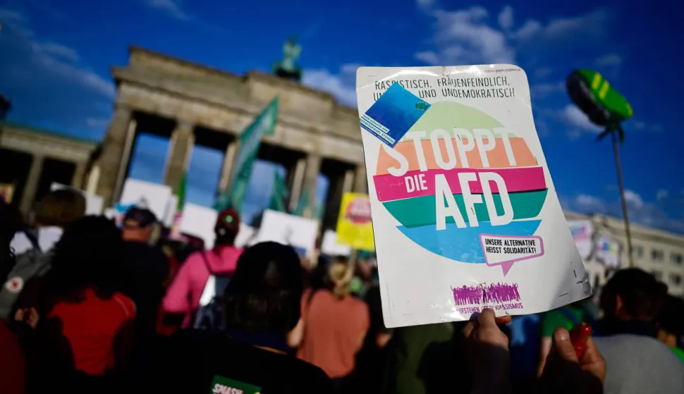People protest during a rally called by the organizations Campact and Fridays for Future named ?Time to Act: Stop the AfD!" at the Brandenburg Gate in Berlin on September 7, 2026, one day after regional elections in the eastern federal state of Saxony-Anhalt. (Photo by John MACDOUGALL/AFP)