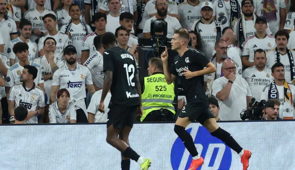 Real Sociedad's Croatian midfielder #24 Luka Susic (R) celebrates scoring his team's first goal during the Spanish league football match between Real Madrid CF and Real Sociedad at Santiago Bernabeu Stadium in Madrid on August 26, 2026. (Photo by Thomas COEX/AFP)
