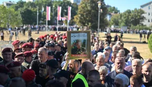 Mourners, holding a portrait of late Bosnian Serb military leader Ratko Mladic, queue as they arrive to take part in a public memorial on the day of his funeral ceremony at St Lukas church in Belgrade, on September 7, 2026. Mladic, 84, died last week after suffering several strokes while serving a life sentence in The Hague for war crimes committed during the 1990s war in Bosnia. (Photo by OLIVER BUNIC/AFP)
