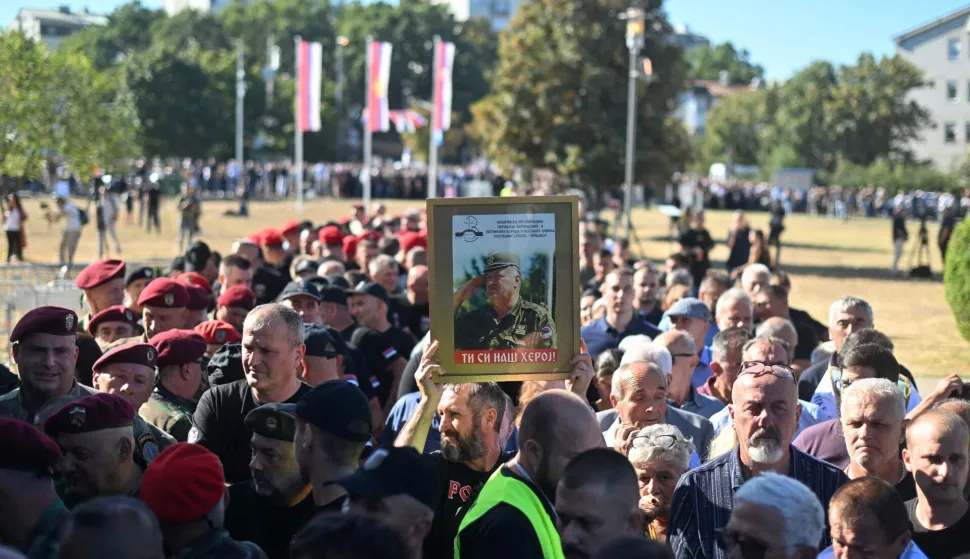 Mourners, holding a portrait of late Bosnian Serb military leader Ratko Mladic, queue as they arrive to take part in a public memorial on the day of his funeral ceremony at St Lukas church in Belgrade, on September 7, 2026. Mladic, 84, died last week after suffering several strokes while serving a life sentence in The Hague for war crimes committed during the 1990s war in Bosnia. (Photo by OLIVER BUNIC/AFP)