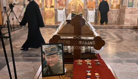 Mourners stands past the coffin of late Bosnian Serb military leader Ratko Mladic while taking part in a public memorial on the day of his funeral ceremony at St Lukas church in Belgrade, on September 7, 2026. Mladic, 84, died last week after suffering several strokes while serving a life sentence in The Hague for war crimes committed during the 1990s war in Bosnia. (Photo by OLIVER BUNIC/AFP)