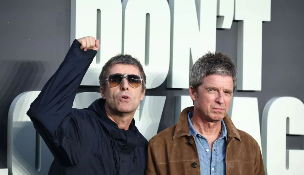 (FILES) British Musicians and Oasis singers Liam Gallagher (L) Noel Gallagher react as they pose upon arrival on the red carpet for the UK premiere of the film 'Oasis: Don't Look Back In Anger', in Leicester Square in central London on September 7, 2026. British rockers Oasis on September 14, announced a new world tour in 2027 with shows planned in Britain, Europe, and the US after the sell-out success of their surprise comeback tour last year. (Photo by Henry NICHOLLS/AFP)