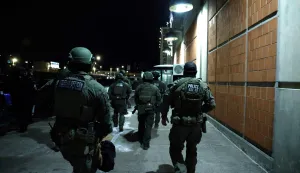 Armed police officers arrive at the Metropolitan Detention facility in the Brooklyn borough of New York, where ousted president Nicolas Maduro is expected to be held, on January 3, 2026 in New York City. President Donald Trump said January 3 that the United States will "run" Venezuela and tap its huge oil reserves after seizing leftist leader Nicolas Maduro during a bombing raid on Caracas.Trump's announcement came hours after a lightning pre-dawn attack in which special forces grabbed Maduro and his wife -- while air strikes pounded sites in and around the capital city -- then whisked him out of the country. (Photo by John Lamparski/AFP)