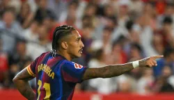 Barcelona's Brazilian forward #11 Raphinha celebrates after scoring a goal during the Spanish league football match between Sevilla FC and FC Barcelona at the Ramon Sanchez Pizjuan stadium in Seville on September 19, 2026. (Photo by JORGE GUERRERO/AFP)