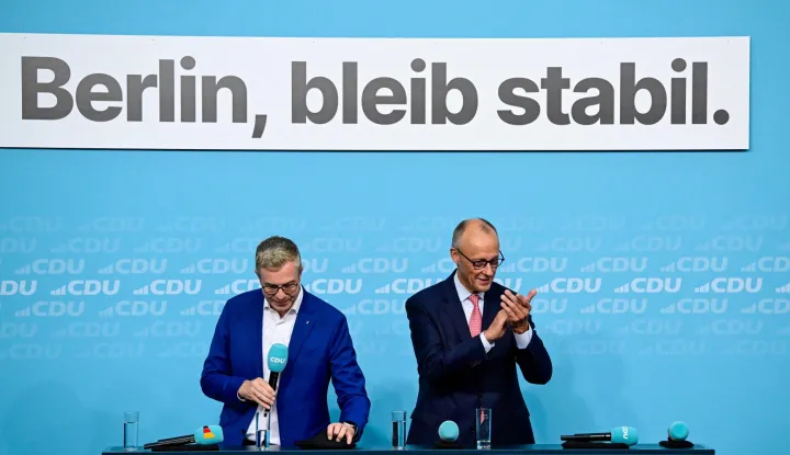 The conservative Christian Democratic Union (CDU) party's lead candidate for the Berlin state election, Stefan Evers (L) looks on as German Chancellor and leader of Germany's Christian Democratic Union (CDU) Friedrich Merz applauds during a campaign event at the CDU headquarters in Berlin, on September 17, 2026. Berlin's State elections take place on September 20, 2026. (Photo by John MACDOUGALL/AFP)