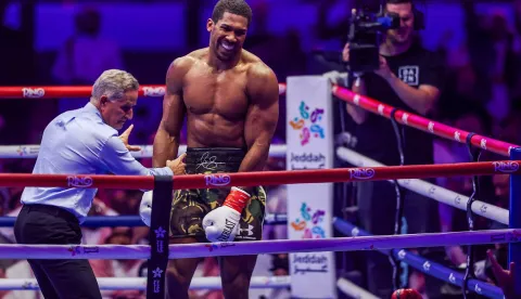 Britain's boxer Anthony Joshua celebrates winning against Albania's boxer Kristian Prenga in their heavyweight boxing fight at the Jeddah Superdome in Jeddah on July 26, 2026. Two-time heavyweight world champion Anthony Joshua survived two early knockdowns on the way to a second-round knockout of Kristian Prenga on July 26, his triumphant ring return paving the way for a blockbuster all-British bout with Tyson Fury. (Photo by AFP)