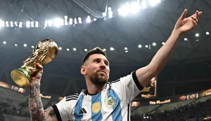(FILES) Argentina's captain and forward #10 Lionel Messi, his wife Antonela Roccuzzo and sons Thiago (C) and Ciro pose with the FIFA World Cup Trophy after Argentina won the Qatar 2022 World Cup final football match between Argentina and France at Lusail Stadium in Lusail, north of Doha on December 18, 2022. Latin American national teams will give an overview of their new projects in the first friendly matches following the 2026 World Cup, during the international break taking place from September 21 to October 6, 2026. (Photo by Anne-Christine POUJOULAT/AFP)