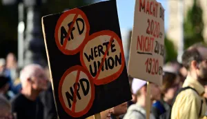 People protest and hold a placards during a rally called by the organizations Campact and Fridays for Future named ?Time to Act: Stop the AfD!" in Berlin on September 7, 2026, one day after regional elections in the eastern federal state of Saxony-Anhalt. (Photo by John MACDOUGALL/AFP)
