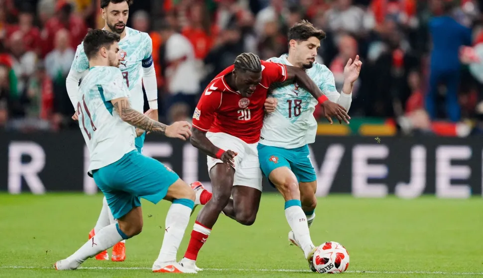 Denmark's midfielder #20 Mohamed Daramy (C) vies for the ball with Portugal's forward #18 Pedro Neto (R) and Portugal's midfielder #21 Ruben Neves (L) during the UEFA Nations League Group A4 match between Denmark and Portugal at Parken stadium in Copenhagen on October 1, 2026. (Photo by Sebastian Elias Uth/Ritzau Scanpix/AFP)/Denmark OUT