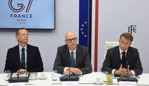 French President Emmanuel Macron (R) speaks next to French Presidential advisor Emmanuel Bonne (L) and France's Economy, Finances and Industry Minister Roland Lescure following a videoconference with G7 leaders from the ?lys?e Presidential Palace in Paris on October 2, 2026. G7 leaders were holding talks on October 2, 2026, to coordinate action on tackling high fuel prices, after Washington upped pressure on Europe to release its strategic reserves or face a US diesel export ban. (Photo by Ludovic MARIN/POOL/AFP)